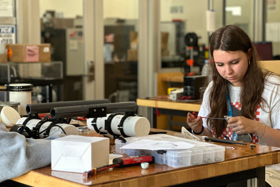 A pre-college student works on an engineering project in LMU design lab